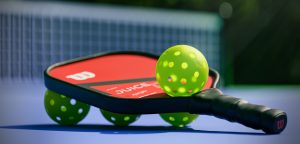 pickleballs and paddle on a court.