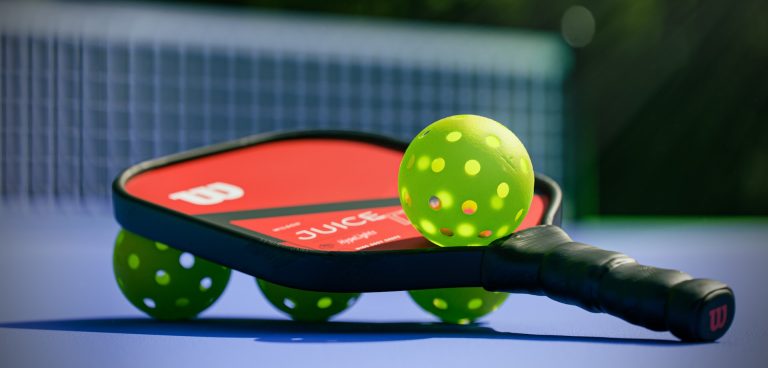 pickleballs and paddle on a court.